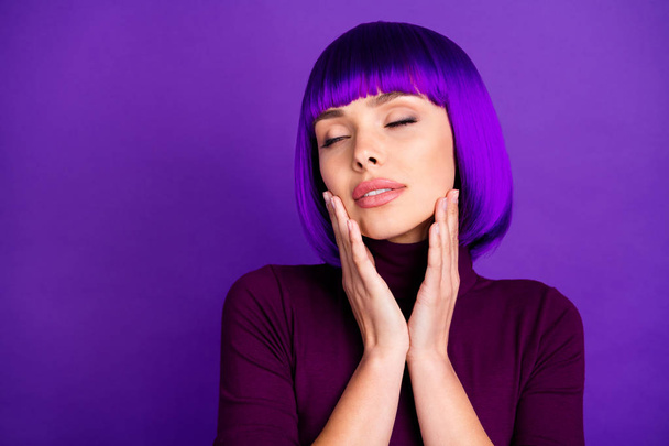 Close up photo of charming girl with her eyes closed touching cheeks wearing turtleneck isolated over violet purple background - Fotoğraf, Görsel