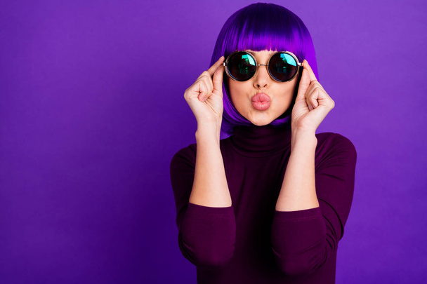 Close up photo of attractive girl touching her specs sending air kisses wearing turtleneck isolated over violet purple background - Zdjęcie, obraz