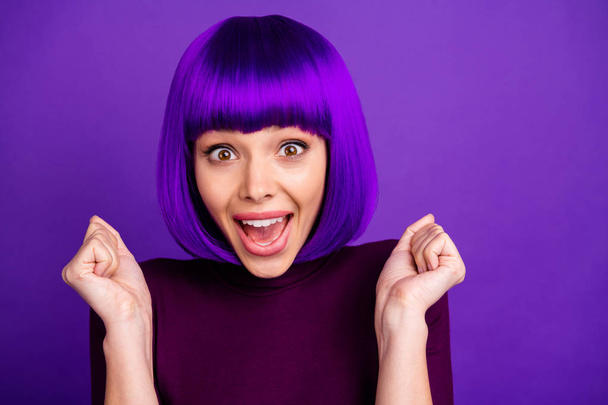 Portrait of cute youth raising her fists screaming wow omg wearing turtleneck isolated over purple violet background - Foto, Imagen