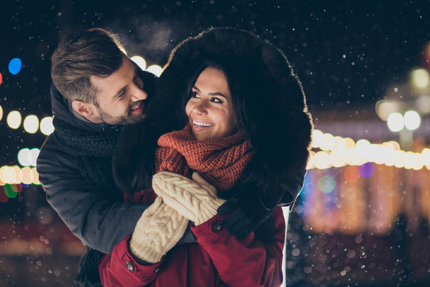 Photo of two people spend x-mas evening near central park tree embracing piggyback wearing warm winter jackets enjoy best company outside - Photo, Image