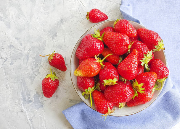 fresh strawberries in a plate on a concrete background - Zdjęcie, obraz