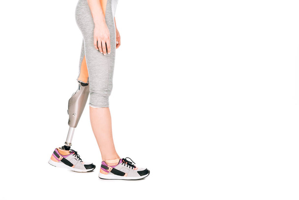 partial view of disabled sportswoman with prosthetic leg isolated on white - Zdjęcie, obraz