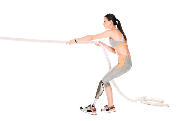 side view of disabled sportswoman training with rope isolated on white - Photo, Image