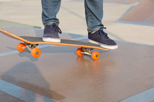 legs skateboarding on skatepark ramp in city - Фото, зображення