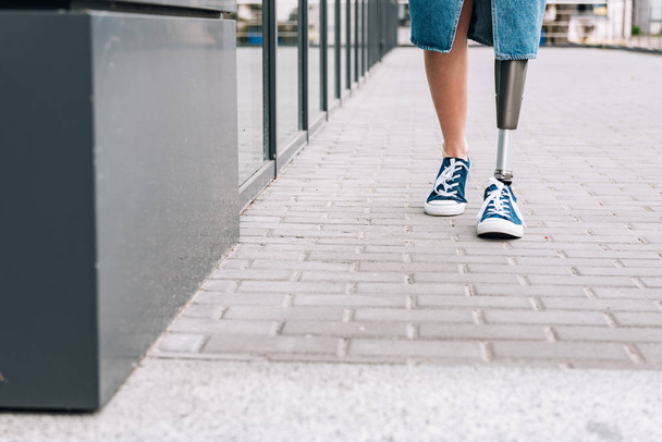 cropped view of disabled woman with prosthetic leg on street - Fotografie, Obrázek