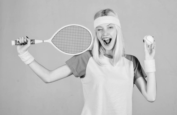 Active leisure and hobby. Athlete hold tennis racket in hand on grey background. Tennis sport and entertainment. Tennis club concept. Girl adorable blonde play tennis. Sport for maintaining health - Φωτογραφία, εικόνα