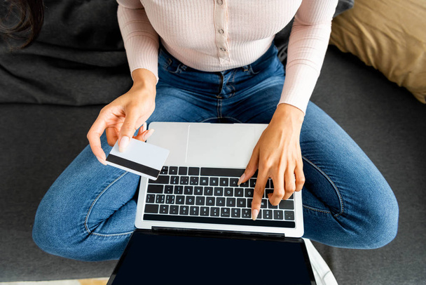 cropped view of african american woman holding credit card and using laptop  - Photo, image