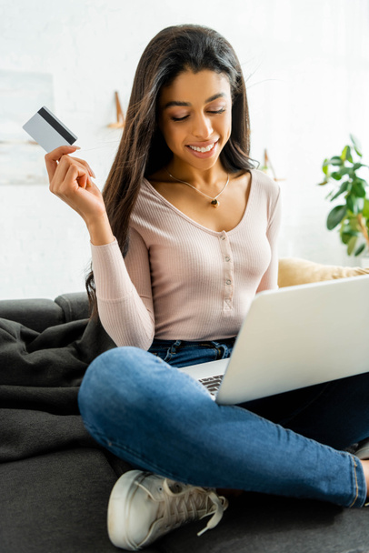 smiling african american woman holding credit card and using laptop  - Photo, Image