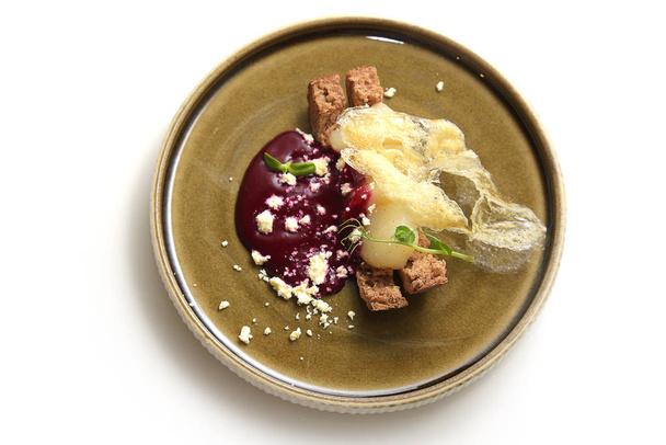 pear dessert with milk sauce on a plate - Foto, Imagen
