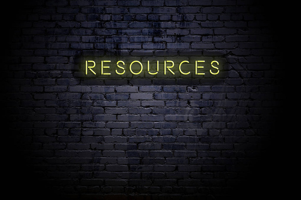Highlighted brick wall with neon inscription resources - Photo, Image