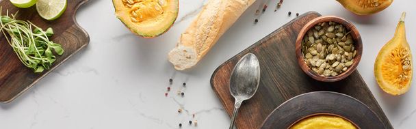 panoramic shot of pumpkin soup and ingredients in marble surface - Photo, Image