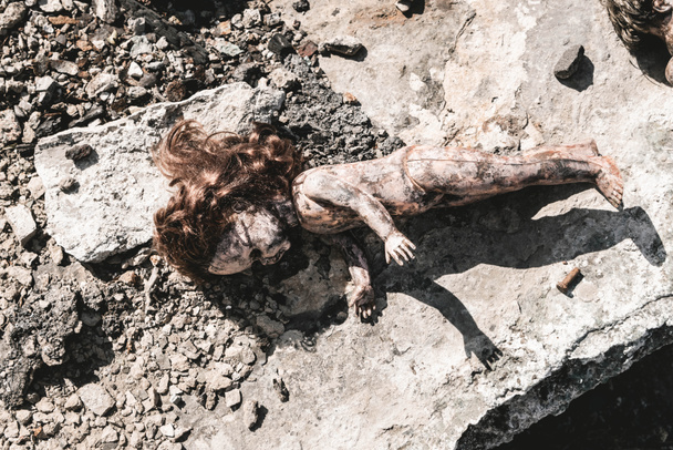 top view of dirty baby doll on ground, post apocalyptic concept - Photo, Image