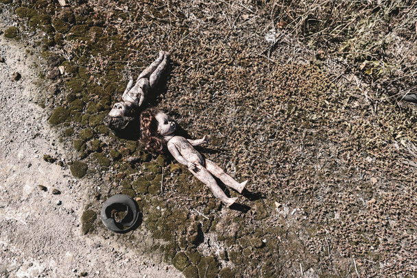 top view of scary and burnt baby dolls on ground, post apocalyptic concept - Foto, Imagem