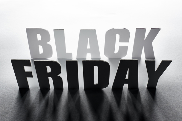 top view of black Friday lettering with shadow on white background - Foto, Imagen