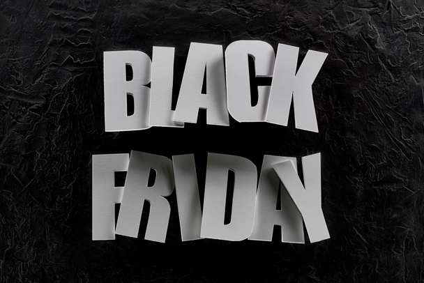 top view of black Friday lettering on black background - Photo, Image