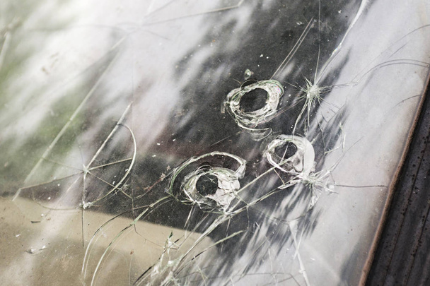 Cracked broken car windshield. Smashed windscreen of a car, damaged glass - Photo, Image
