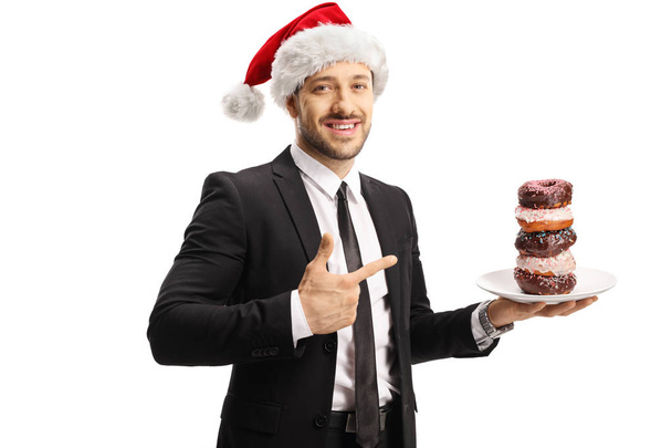 Businessman with a Santa Claus hat holding a plate with chocolat - Photo, image