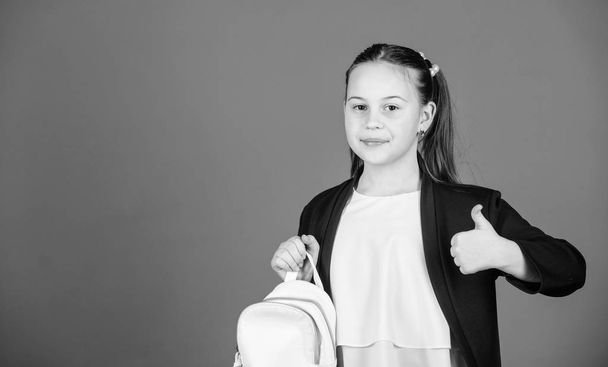 Girl little fashionable cutie carry backpack. Kids fashion trend concept. Schoolgirl formal style clothes with small cute backpack. Do not forget your backpack. Learn how fit backpack correctly - Foto, Bild