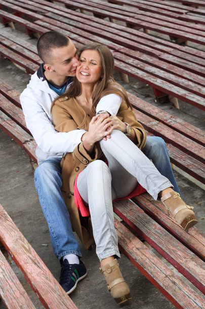 Stylish young couple hugging at a sports stadium outdoor. - Valokuva, kuva