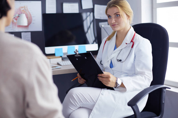 Woman doctor explaining diagnosis to her female patient - Photo, image