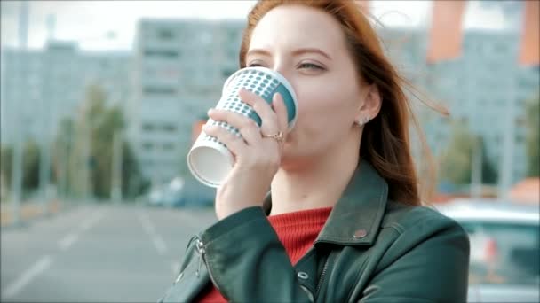 Young Woman Drinking Coffee on the Street, Young Girl With Glasses of a Happy Woman with Long Red Hair in a Good Mood, Positive Emotions. - Záběry, video