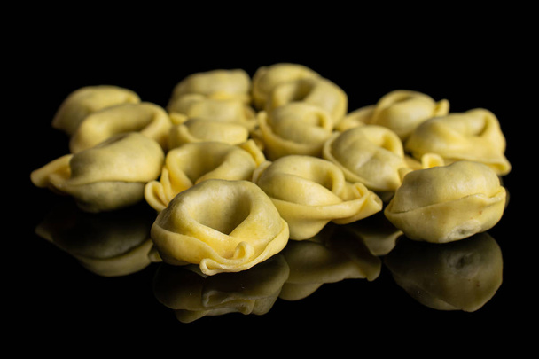 Spinach filled tortelloni isolated on black glass - Photo, image