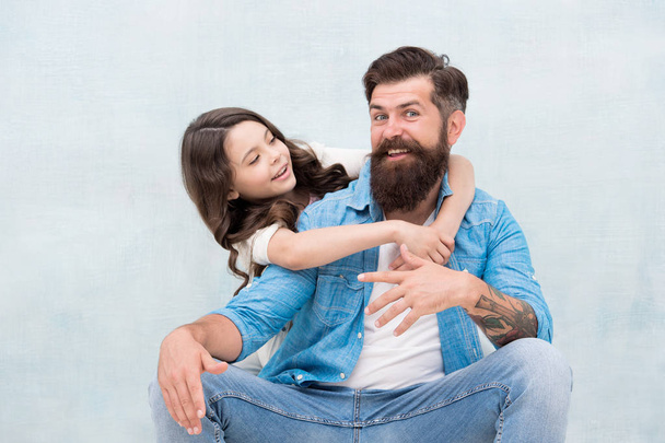 Honoring fathers and celebrating fatherhood. Little daughter hugging father on fathers day. Bearded man and small child celebrating international fathers day together. Happy fathers day - Фото, изображение