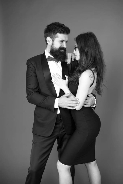 Elegance is not about being noticed. Award ceremony concept. Bearded man wear suit girl elegant dress. Formal dress code. Visiting event or ceremony. Couple ready for award ceremony. Corporate party - Fotografie, Obrázek