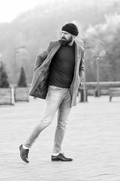 Hipster outfit and hat accessory. Stylish casual outfit spring season. Menswear and male fashion concept. Man bearded hipster stylish fashionable coat and hat. Comfortable outfit. Lumbersexual style - Photo, image