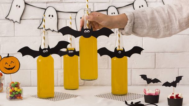 Halloween beer in glass bottles with paper bats on the top - Photo, Image
