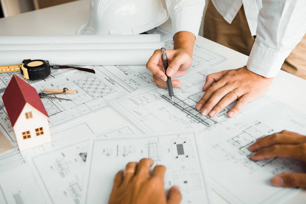 Architects engineer working with blueprints on table and discuss - Photo, Image