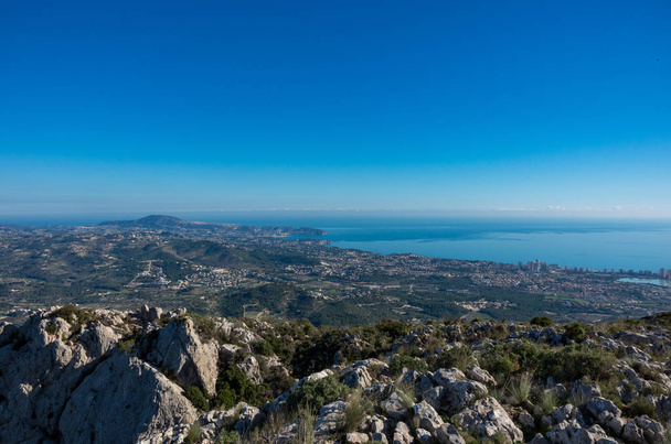 Panoramic view of the Mediterranean Sea and the Calpe region from the cliffs of the Sierra d'Olt mountain range, Spain - Photo, Image