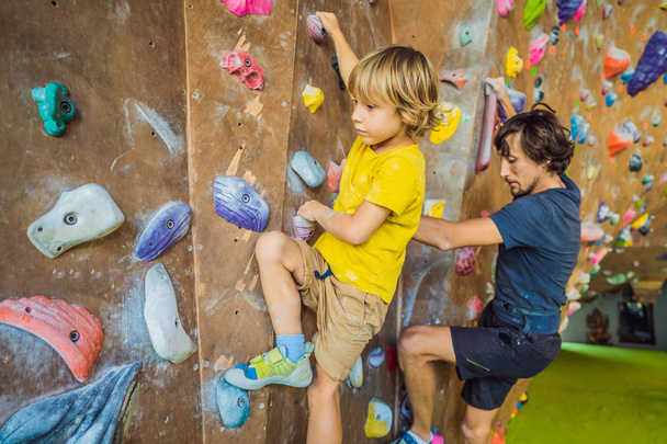 Dad and son at the climbing wall. Family sport, healthy lifestyle, happy family - Foto, Imagen