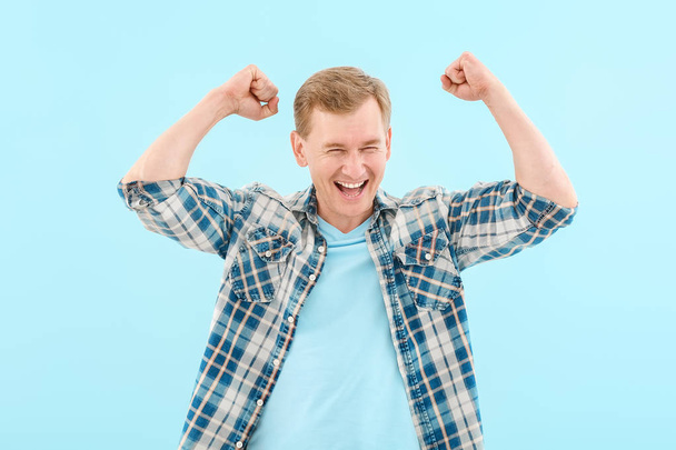 Portrait of handsome happy man on color background - Photo, Image
