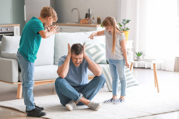 Angry children scolding their father at home - Photo, Image