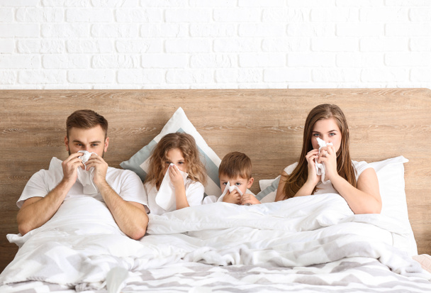Family ill with flu in bed at home - Photo, Image