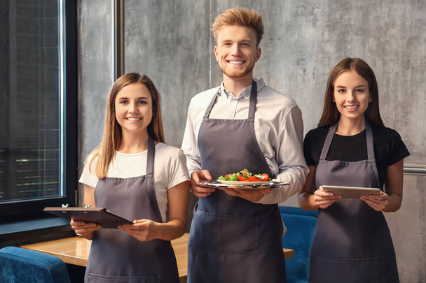 Team of young waiters in restaurant - Photo, Image