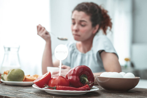 Curly red-haired woman having allergy to red vegetables - Fotografie, Obrázek
