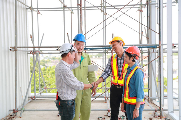 portrait of engineer people shaking hands after finish successful project at construction site - Φωτογραφία, εικόνα