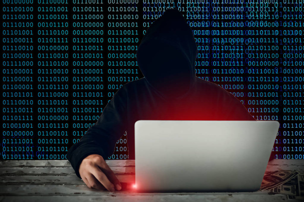 hacker wearing black hooded hacking and stealing big data and finance information from computer and copying them to USB flash drive  - Фото, изображение