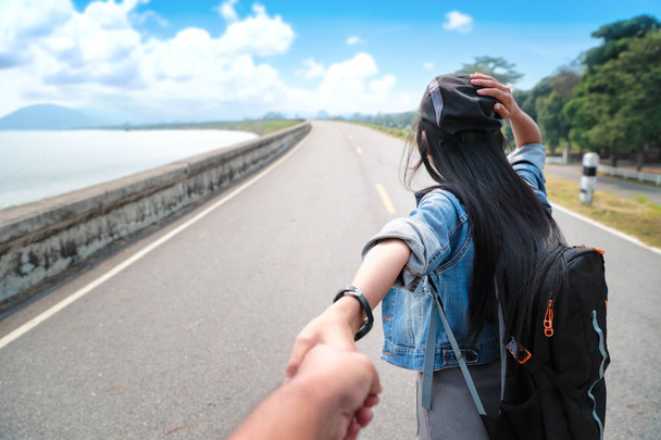 um casal jovem asiático viajante segurando mão com mochila enquanto viaja de férias
 - Foto, Imagem