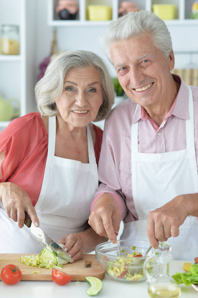 Senior couple cooking together at kitchen   - Фото, зображення