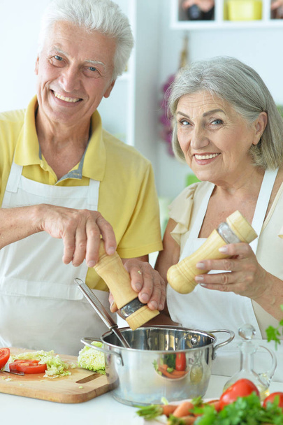 Senior couple cooking together at kitchen   - Фото, изображение
