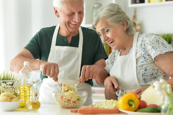 Senior couple cooking together at kitchen   - Zdjęcie, obraz