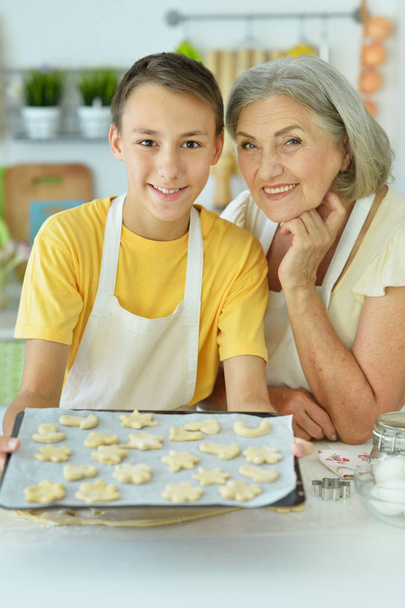senior woman and boy  baking  delicious cookies  - 写真・画像