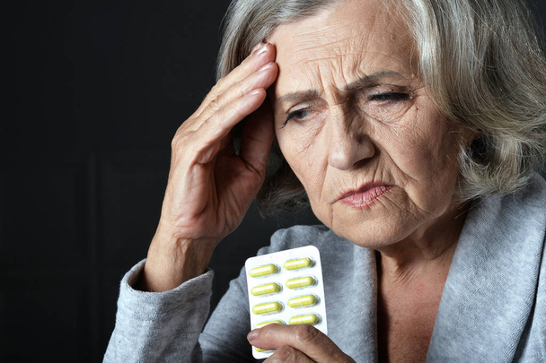Close up portrait of sad senior woman with headache  - Фото, изображение