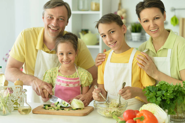 Cute family cooking together in kitchen - Foto, imagen