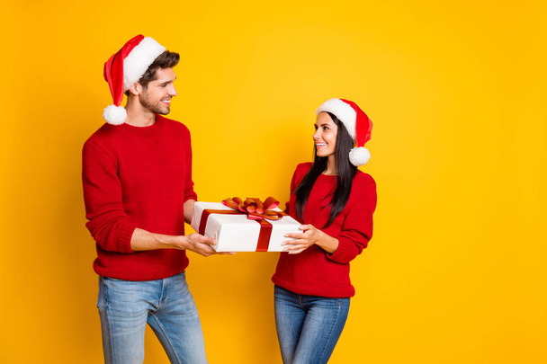 Profile side photo of charming two married people get give packages wear red pullover denim jeans isolated over yellow background - Φωτογραφία, εικόνα