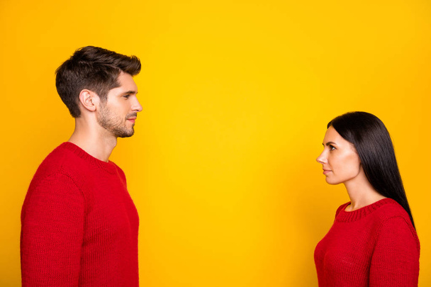 Profile side photo of concentared man and woman stare face-to face wear red pullover isolated over yellow background - Fotoğraf, Görsel