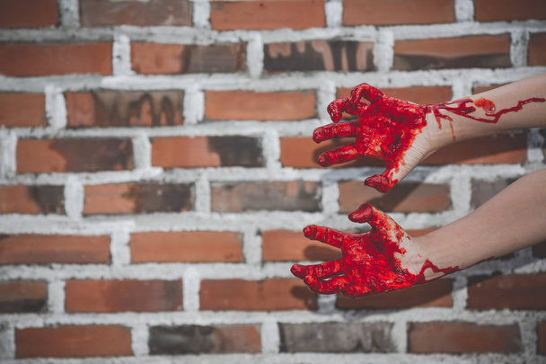 A bloody hand of a female ghost or a zombie on a background of a - Foto, Imagem